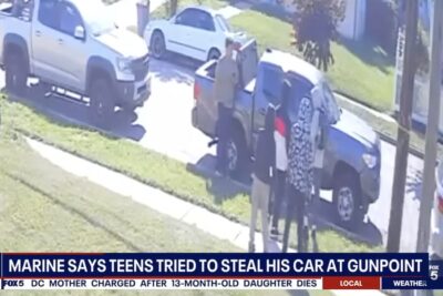 Surveillance camera image shows Marine veteran Jacob Bordeaux standing beside his pickup truck as four teenagers approach him moments before an alleged armed carjacking attempt in Oxon Hill, Maryland.