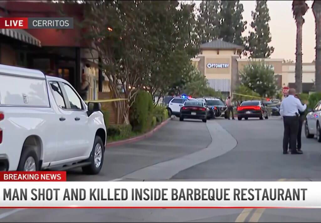 Law enforcement officers secure the scene outside a barbecue restaurant in Cerritos, California, after a concealed carry permit holder fatally shot a knife-wielding man.