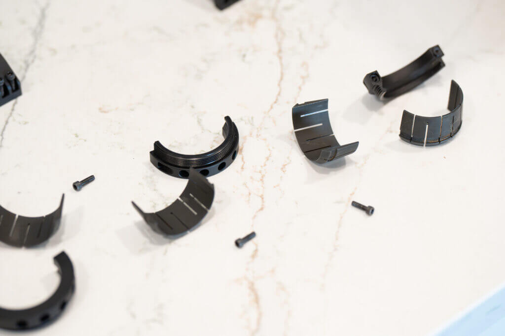 Steel segmented collets used inside the Project 47 Force 360 scope mounting system