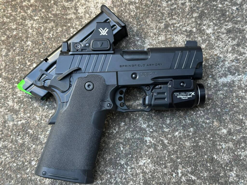Springfield Prodigy 3.5 AOS on concrete with Streamlight TLR-7 X weapon light installed
