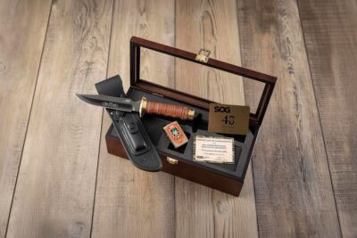 The limited-edition SOG 40th Anniversary Fat Guard Bowie knife displayed with its commemorative collector accessories.