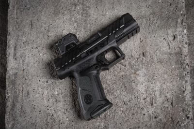 A Steiner MPS 2.0 enclosed-emitter red dot mounted on a full-size optics-ready pistol resting on a concrete surface.
