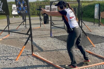 Jessie Harrison fires an Open Division pistol while competing on a USPSA stage.
