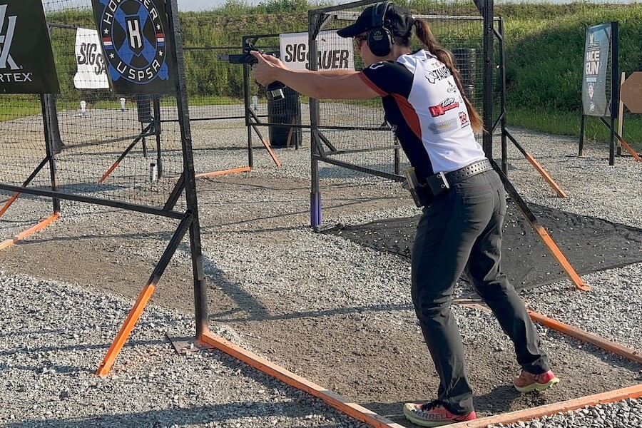 Jessie Harrison fires an Open Division pistol while competing on a USPSA stage.