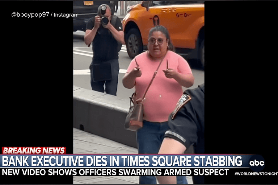 Pamela Cisneros holding two knives while surrounded by NYPD officers in Times Square.