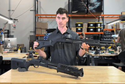 Mitchell Booth displays two LTT Mossberg 590 defensive pump-action shotguns at Langdon Tactical.