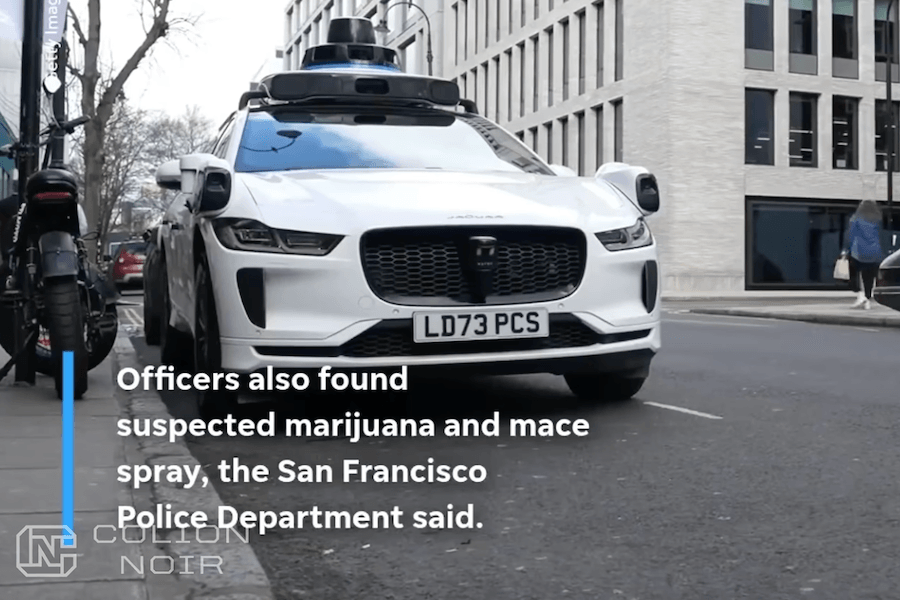 White Jaguar equipped with autonomous-driving sensors on a city street, shown in Colion Noir’s video.