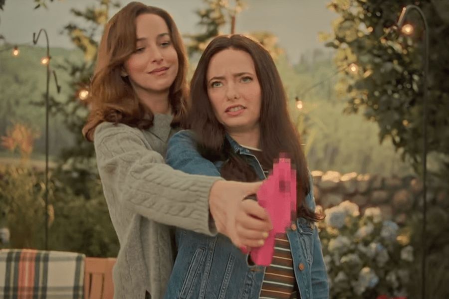 Dakota Johnson demonstrates a blurred pink prop gun during SNL’s “Guns for Women” sketch.