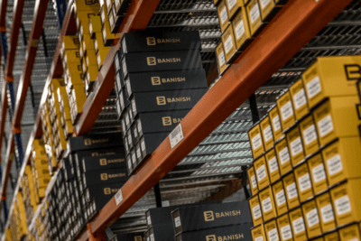 Shelves filled with boxed BANISH suppressors inside a Silencer Central warehouse.